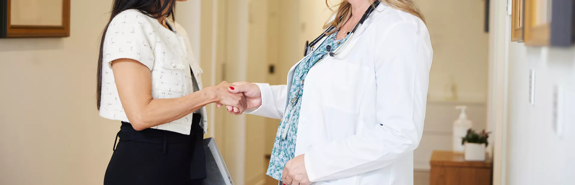 Two women shaking hands