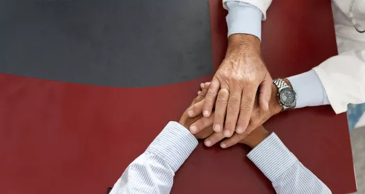 Un medico tiene le mani a un paziente 