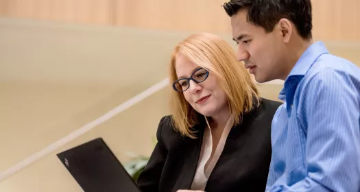 Woman and man looking at laptop