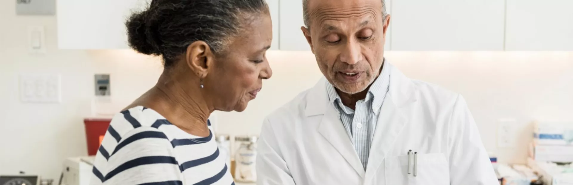 A doctor discusses different clinical trial options with a patient.