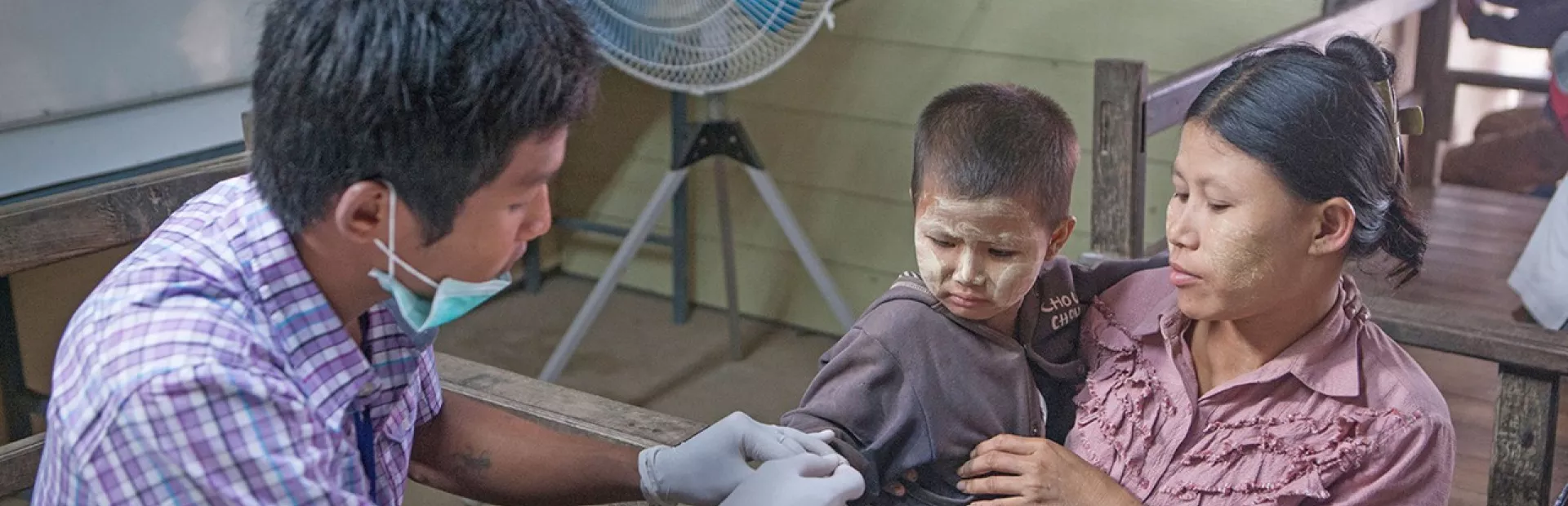 Young child next to his mother getting examine