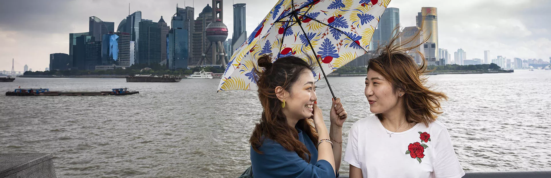 Portrait of two chinese women holding an umbrella