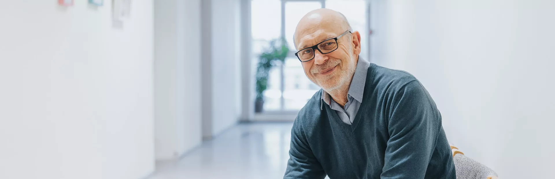 Elder man with glasses smiling