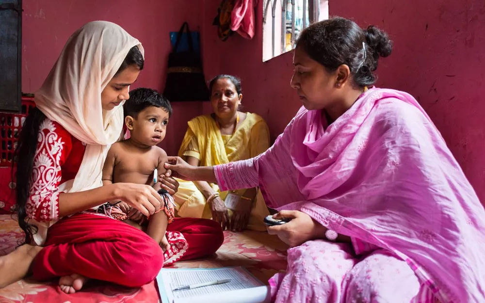 A field research assistant carries out routine checks to screen for pneumonia, the leading cause of death among young children worldwide.