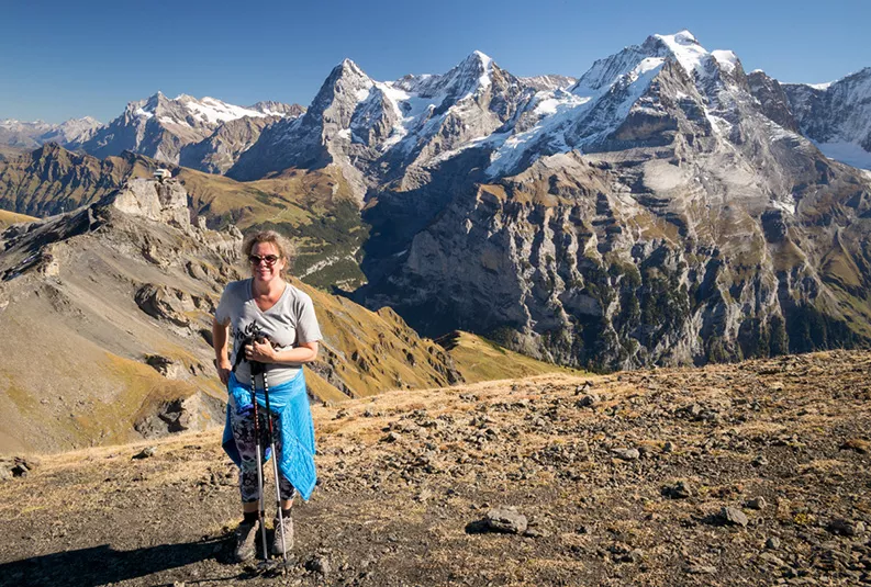 Lauren Abrey on vacation hikes up a large mountain