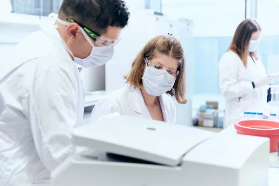 Three scientists working in a modern lab