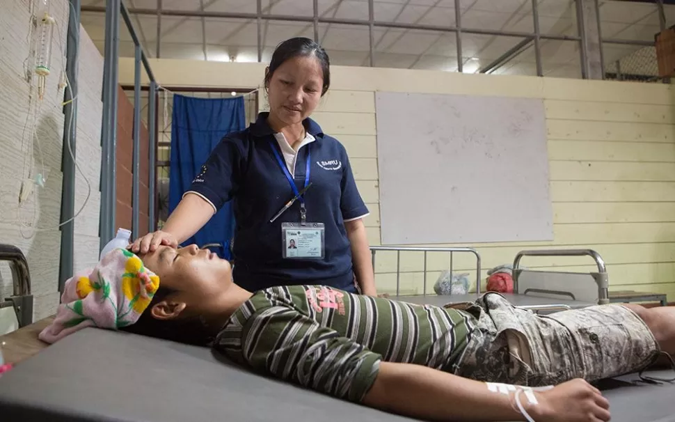 A nurse treating a patient.