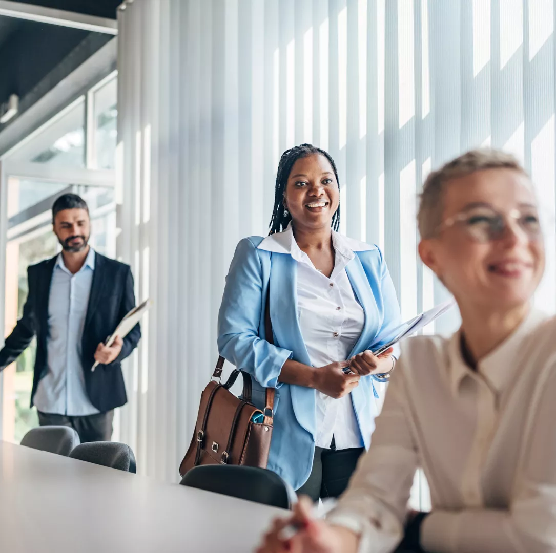 Business persons entering meeting room