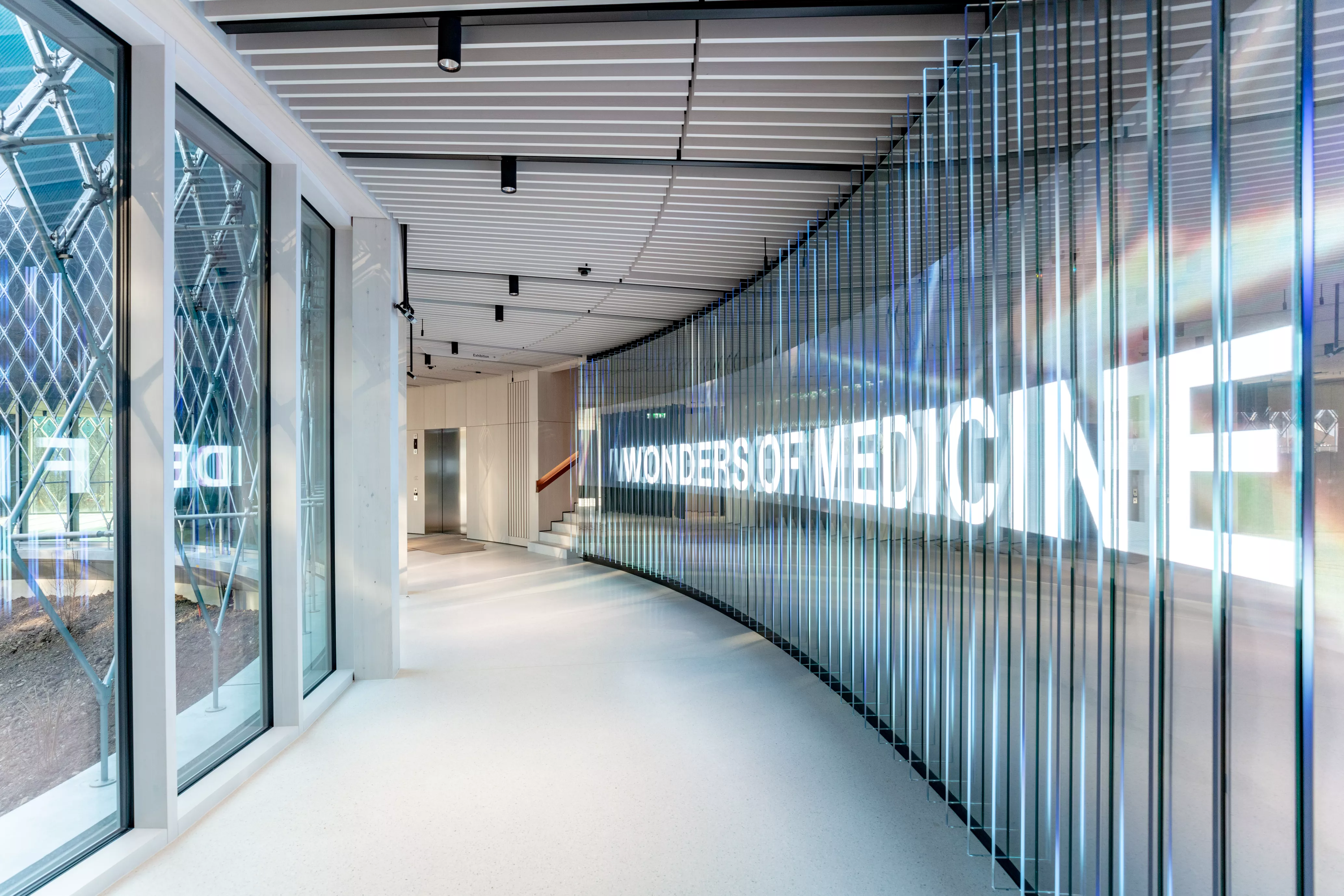 Welcome wall and staircase to the exhibition Wonders of Medicine in the Novartis Pavillon