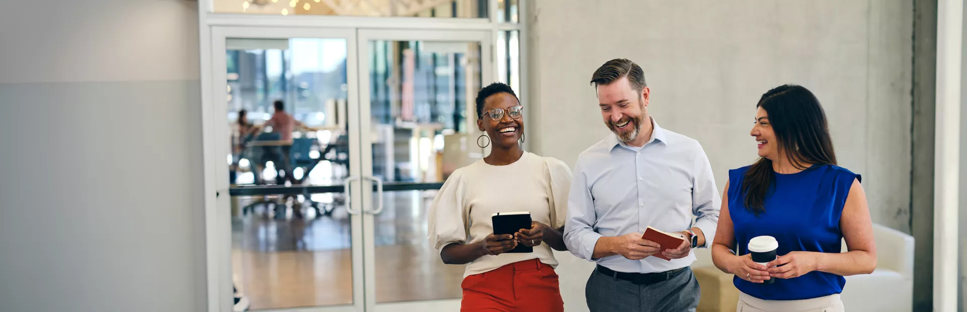 Three business people laughing