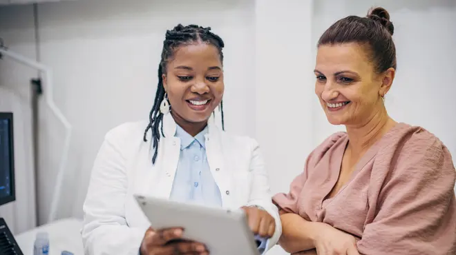 Doctor and patient interacting on medical results Doctor and patient interacting on medical results