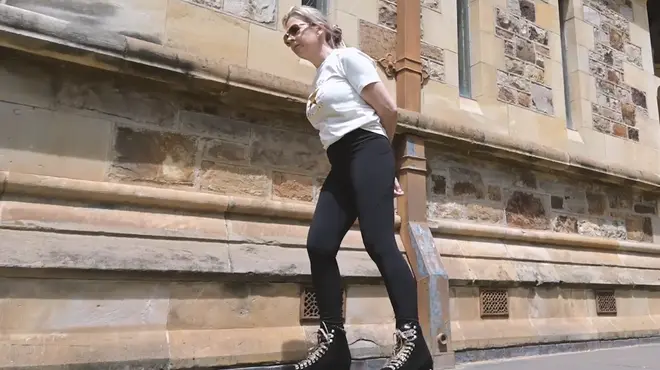 Victoria roller skates past a historic stone building Victoria roller skates past a historic stone building